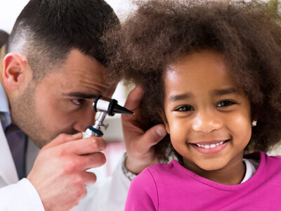 Smiling Little African Girl With Ear Specialist