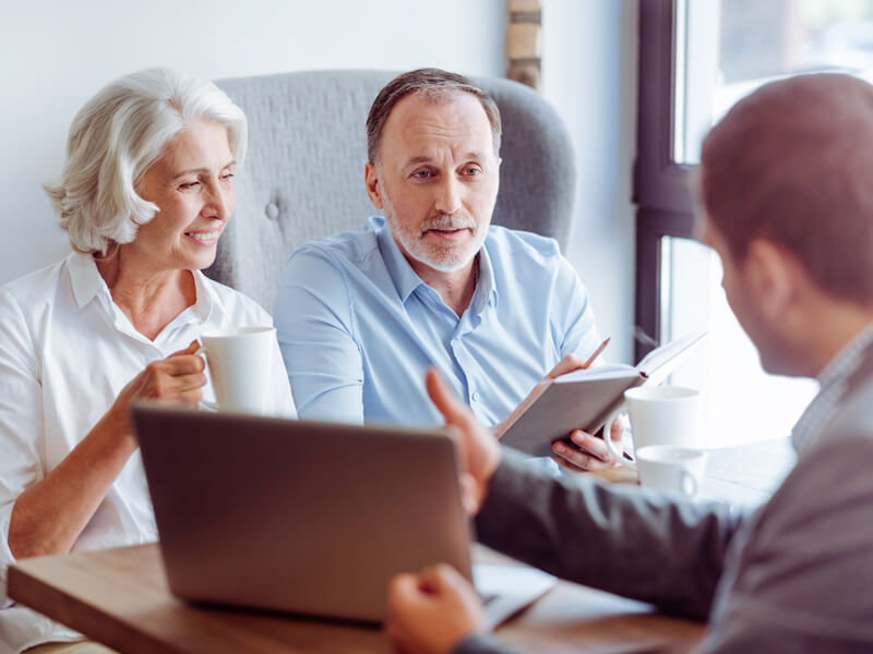 Positive Aged Couple Consulting With Insurance Agent