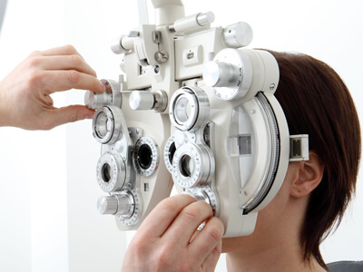 Woman Doing Eyesight Measurement With Optical Phoropter